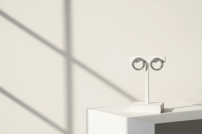 Silver Circle Stud Earrings on white stand with shadow backdrop | OriaJewel