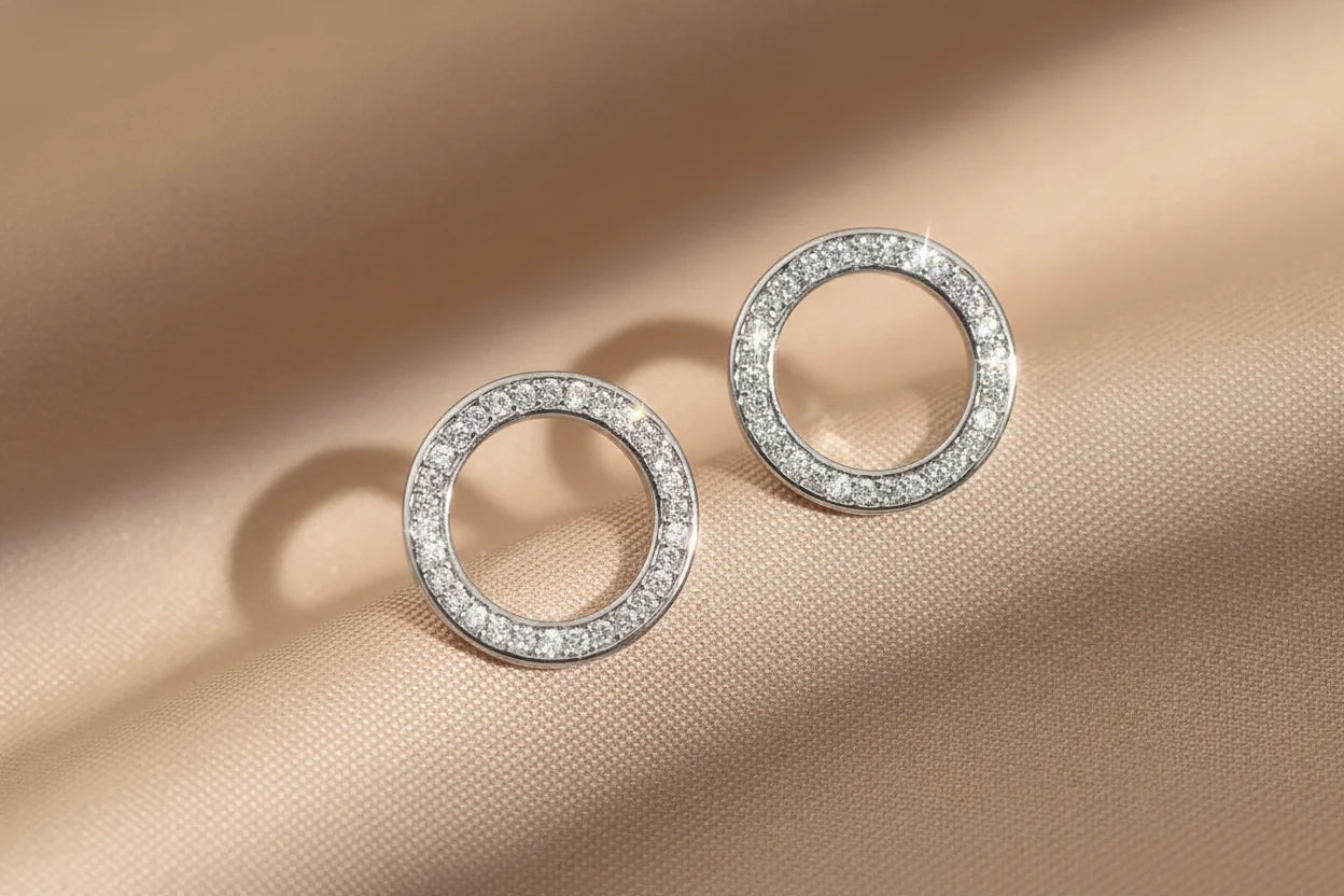 Silver Circle Stud Earrings close-up on satin fabric | OriaJewel