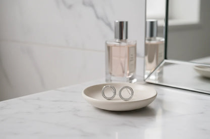 Silver Circle Stud Earrings on vanity dish with perfume | OriaJewel