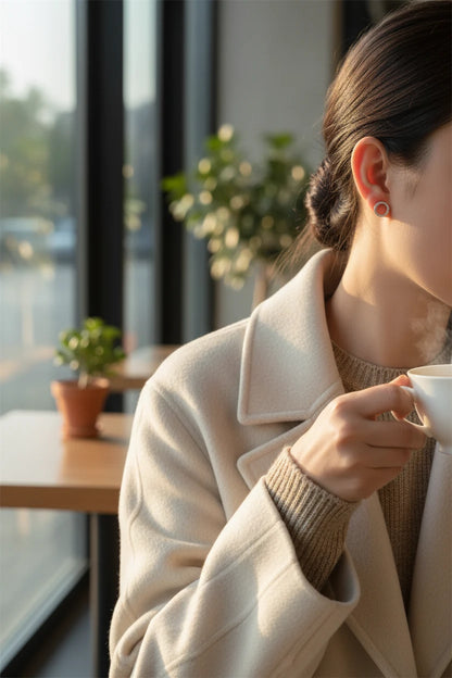 Silver Circle Stud Earrings worn on model with coffee in café | OriaJewel