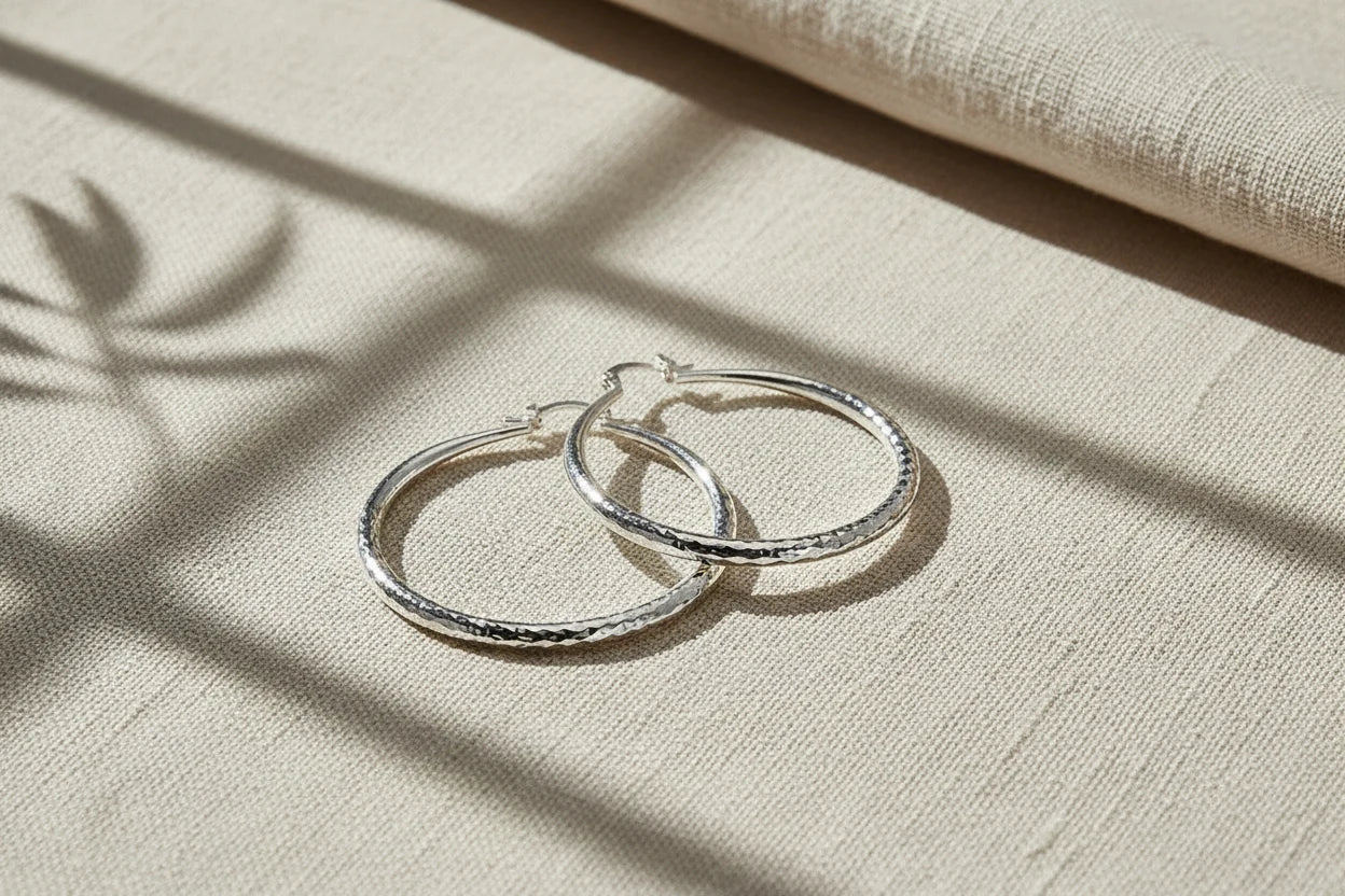 Silver Classic Hoop Earrings on soft fabric with window shadows | OriaJewel