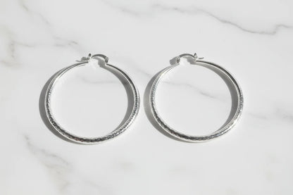 Silver Classic Hoop Earrings pair on marble background | OriaJewel
