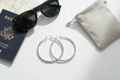 Silver Classic Hoop Earrings flat lay with sunglasses and passport | OriaJewel
