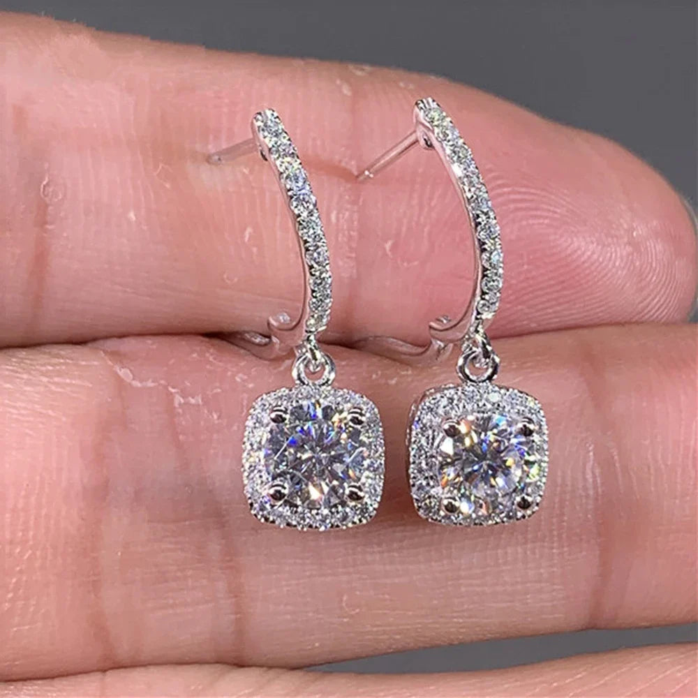 Silver Crystal Drop Huggie Earrings in-hand close-up with cushion halo drops | OriaJewel