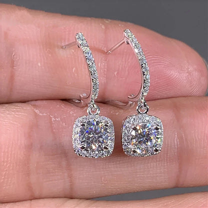 Silver Crystal Drop Huggie Earrings in-hand close-up with cushion halo drops | OriaJewel