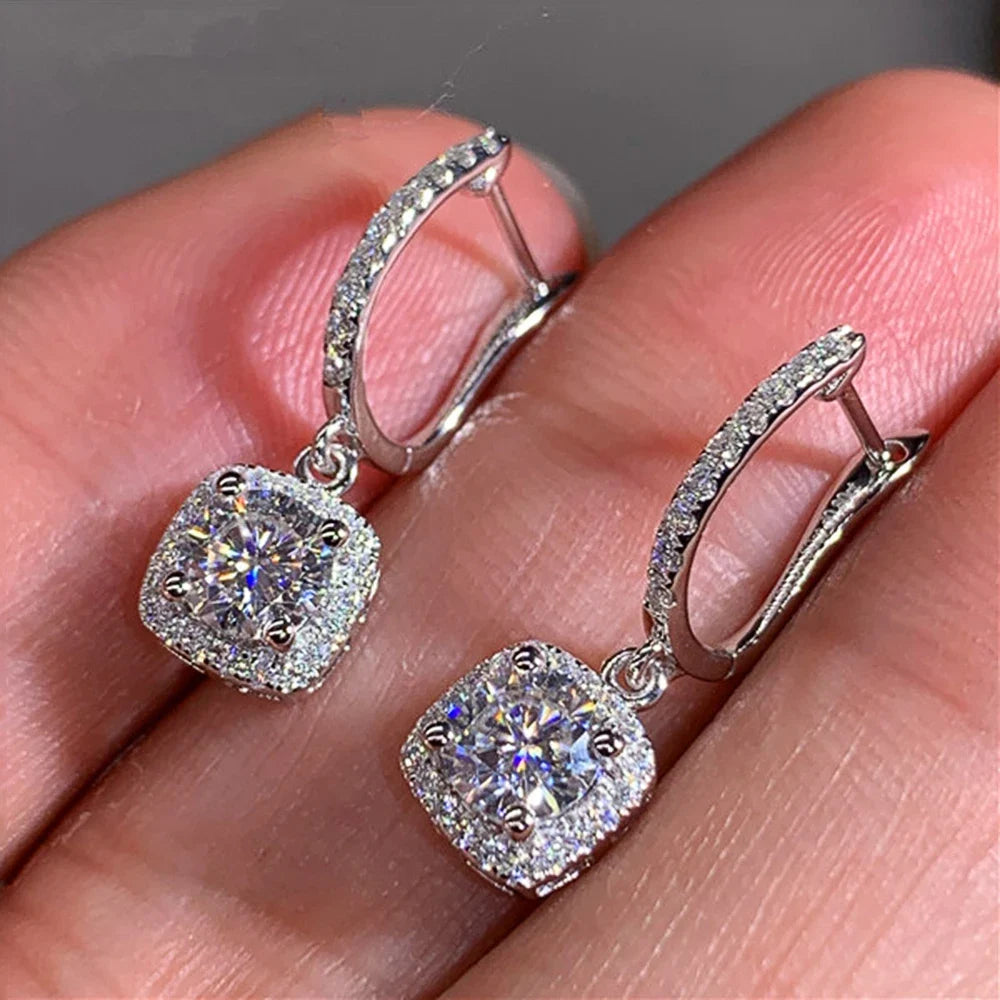 Silver Crystal Drop Huggie Earrings in-hand angled view showing clasp | OriaJewel