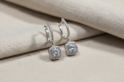 Silver Crystal Drop Huggie Earrings on beige fabric with soft folds | OriaJewel