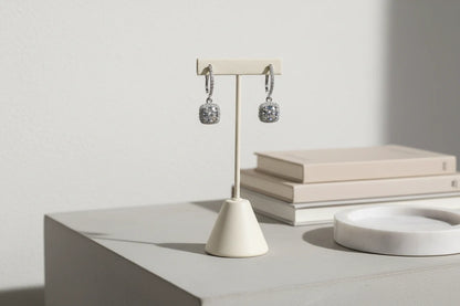 Silver Crystal Drop Huggie Earrings on stand with books on table | OriaJewel