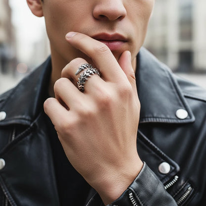 Silver Fishbone Ring worn on a man’s hand near the lips with a leather jacket, focusing on the chunky fishbone wrap design and textured silver finish in an urban lifestyle portrait | OriaJewel