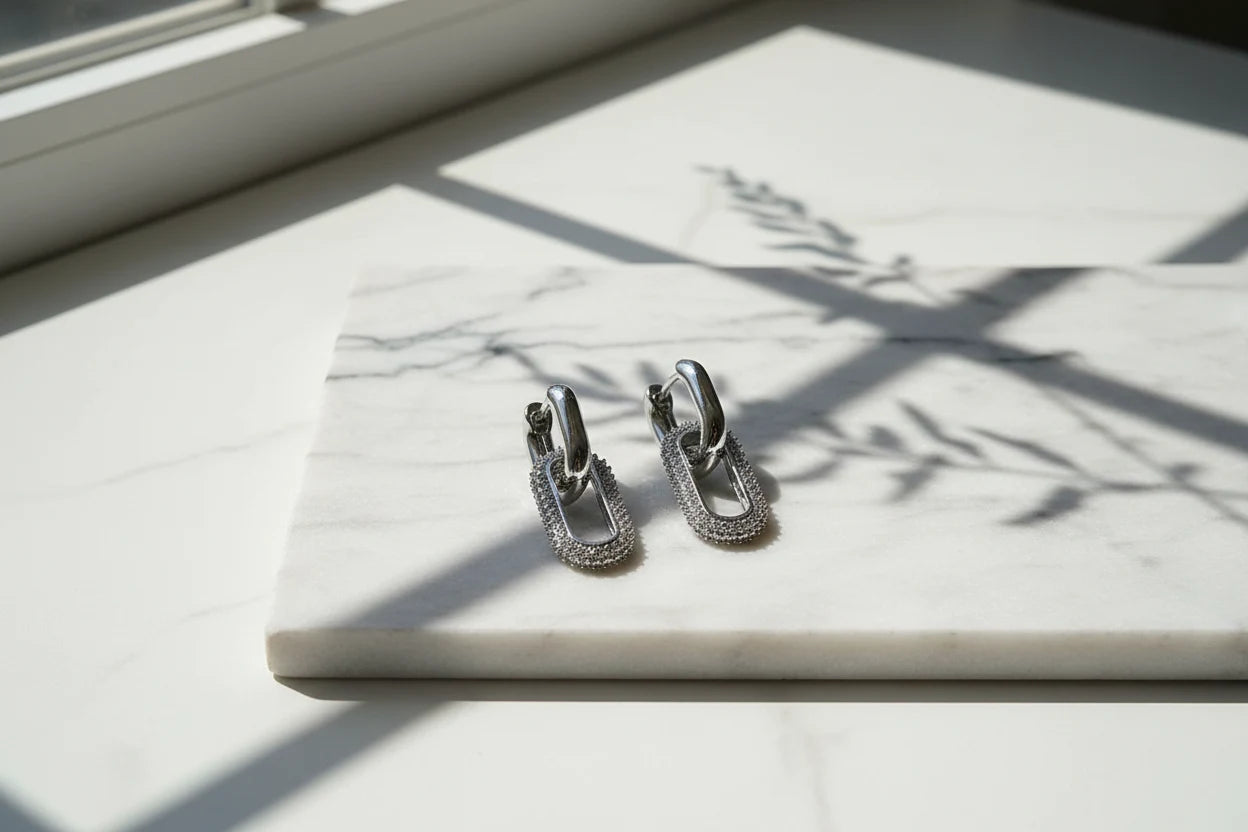 Silver Link Drop Earrings on marble slab with sunlight shadows, pavé oval link drop | OriaJewel