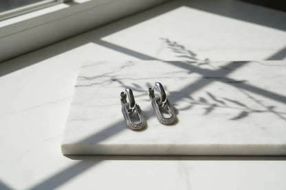 Silver Link Drop Earrings on marble slab with sunlight shadows, pavé oval link drop | OriaJewel