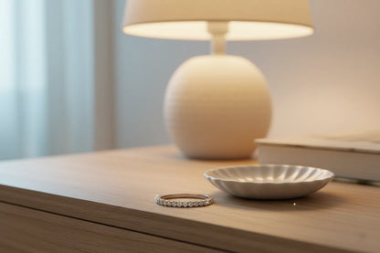 Silver Midi Ring Set slim pavé band on a wooden table beside a lamp and small dish, warm cozy lighting and soft blur | OriaJewel