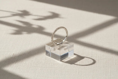 Silver Midi Ring Set displayed upright on a clear stand with window-light shadows, clean minimal product presentation | OriaJewel