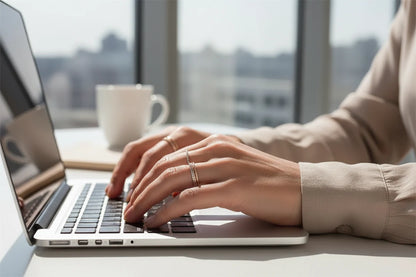 Silver Midi Ring Set worn while typing on a laptop, modern workday scene with sunlight and city view background | OriaJewel