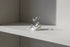 Silver Pavé Snake Wrap Ring displayed on a small white ring holder on a clean shelf, side-angle studio scene emphasizing the open wrap design and shimmering pavé finish | OriaJewel
