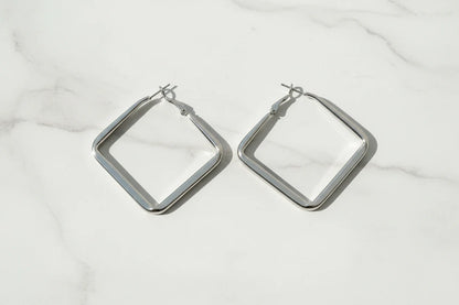 Silver Square Hoop Earrings on marble surface in soft daylight | OriaJewel