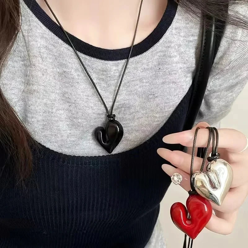 Simple Heart Pendant Necklace showcased on a person, featuring black, silver, and red heart designs | Oria Jewel