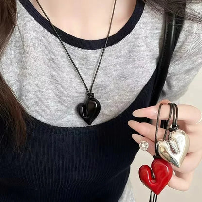 Simple Heart Pendant Necklace showcased on a person, featuring black, silver, and red heart designs | Oria Jewel