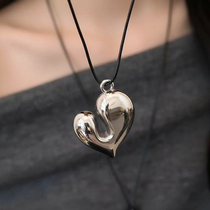 Simple Heart Pendant Necklace showcased on a model, featuring a shiny heart-shaped pendant on a black cord | Oria Jewel