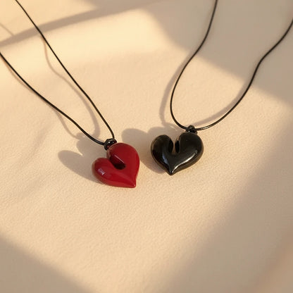 Simple Heart Pendant Necklace featuring red and black heart-shaped pendants on a black cord | Oria Jewel