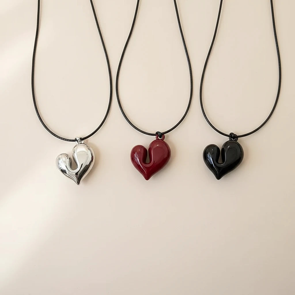 Simple Heart Pendant Necklace in silver, red, and black hanging on cords against a soft background | Oria Jewel