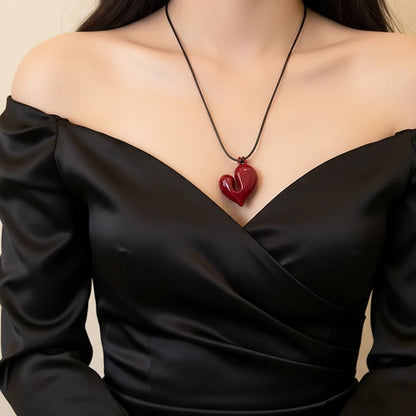 Simple Heart Pendant Necklace worn with an elegant black off-shoulder dress, showcasing its unique heart shape | Oria Jewel