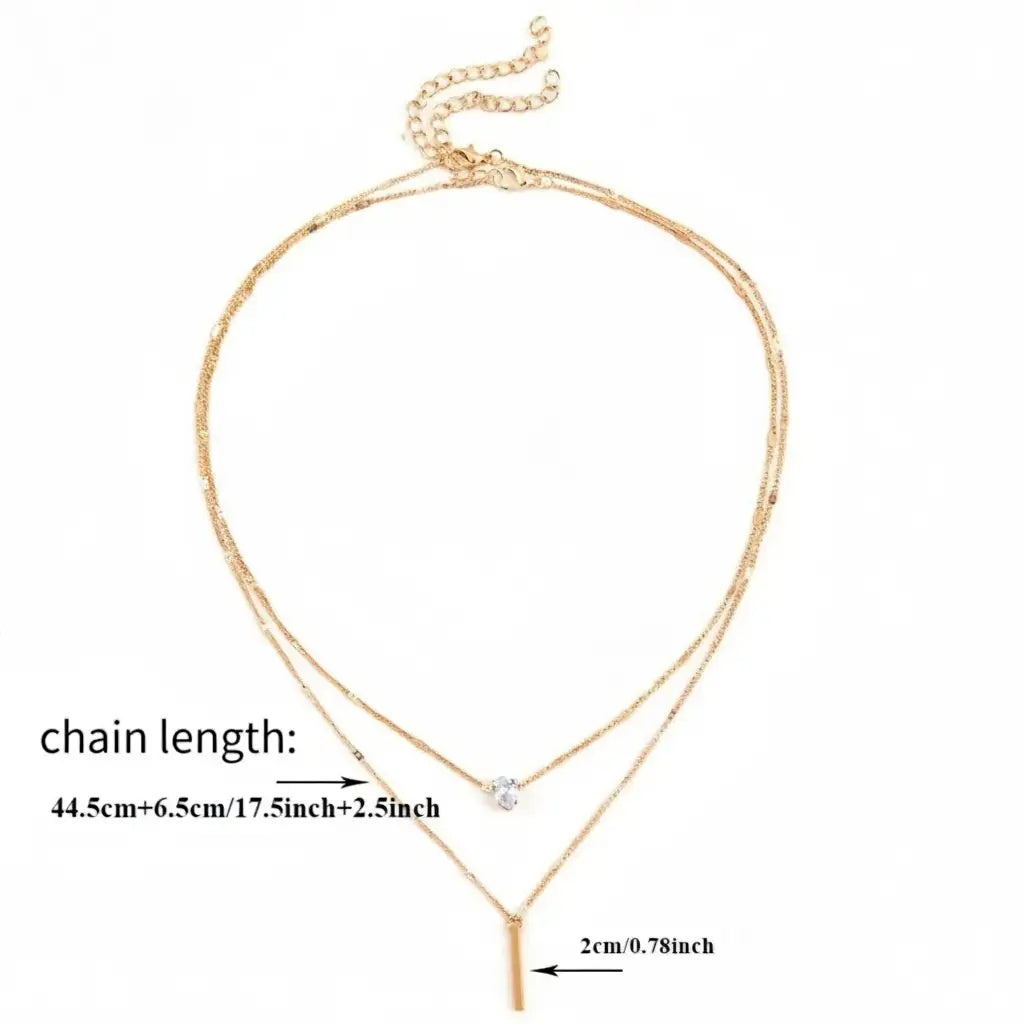 Product shot of gold Star Layered Necklace on white background with clear measurements of chain length and bar pendant size | Oria Jewel