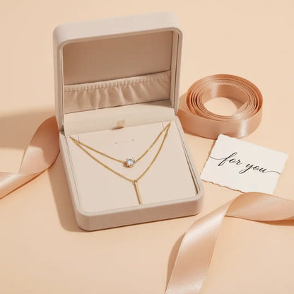 Gift-ready presentation of gold Star Layered Necklace inside a beige jewelry box with satin ribbons and “for you” card beside it | Oria Jewel