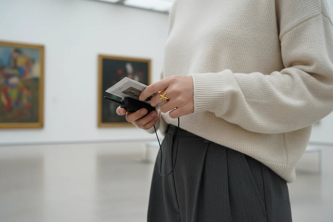 Starfish Gold Ring worn in a gallery setting while holding a camera, casual knit outfit and soft light highlighting the seaside statement design | OriaJewel