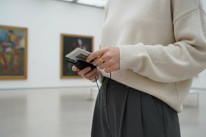 Starfish Gold Ring worn in a gallery setting while holding a camera, casual knit outfit and soft light highlighting the seaside statement design | OriaJewel