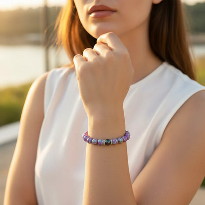 Elegant woman in a white sleeveless top showcasing the Stress Relief Gemstone Bracelet on her wrist outdoors | Oria Jewel