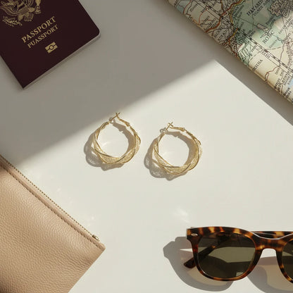 Twisted Crossover Hoop Earrings flat lay with passport and sunglasses | OriaJewel