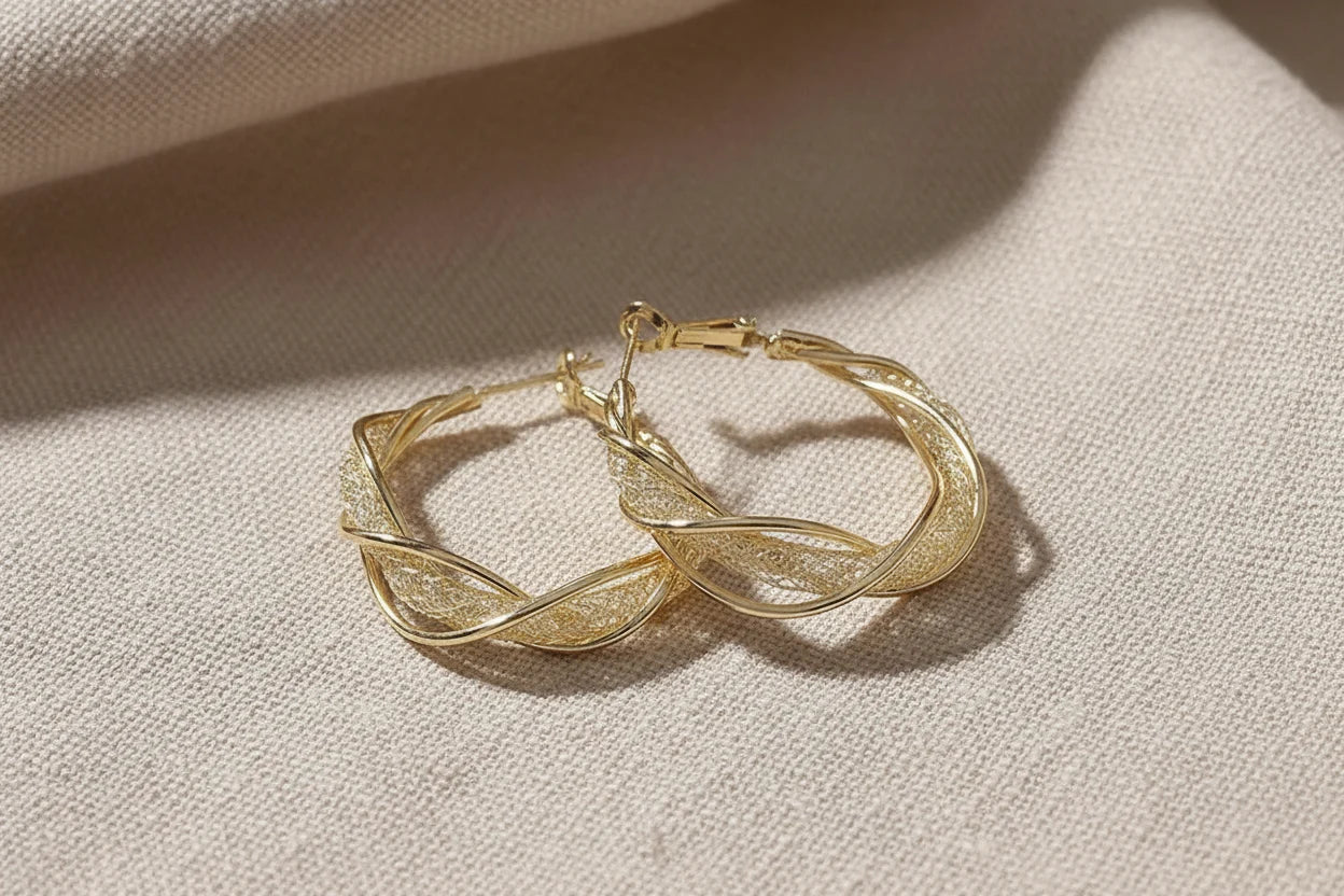 Twisted Crossover Hoop Earrings on linen fabric close-up | OriaJewel