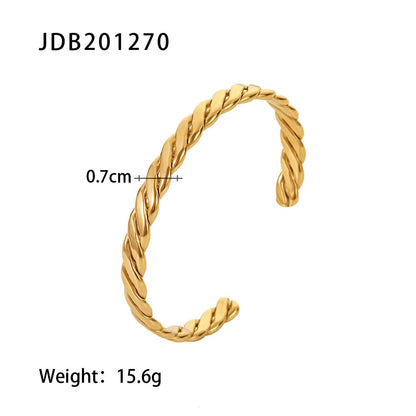 Studio product shot of a Twisted Gold Cuff Bracelet on a white background with size measurements and weight displayed, highlighting its polished twisted design and comfortable open cuff fit | Oria Jewel