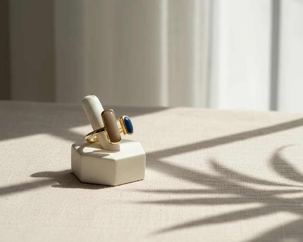 Two Stone Open Ring displayed on a minimalist ring stand in warm window light, fabric backdrop with soft plant shadows, showing the open adjustable fit | OriaJewel