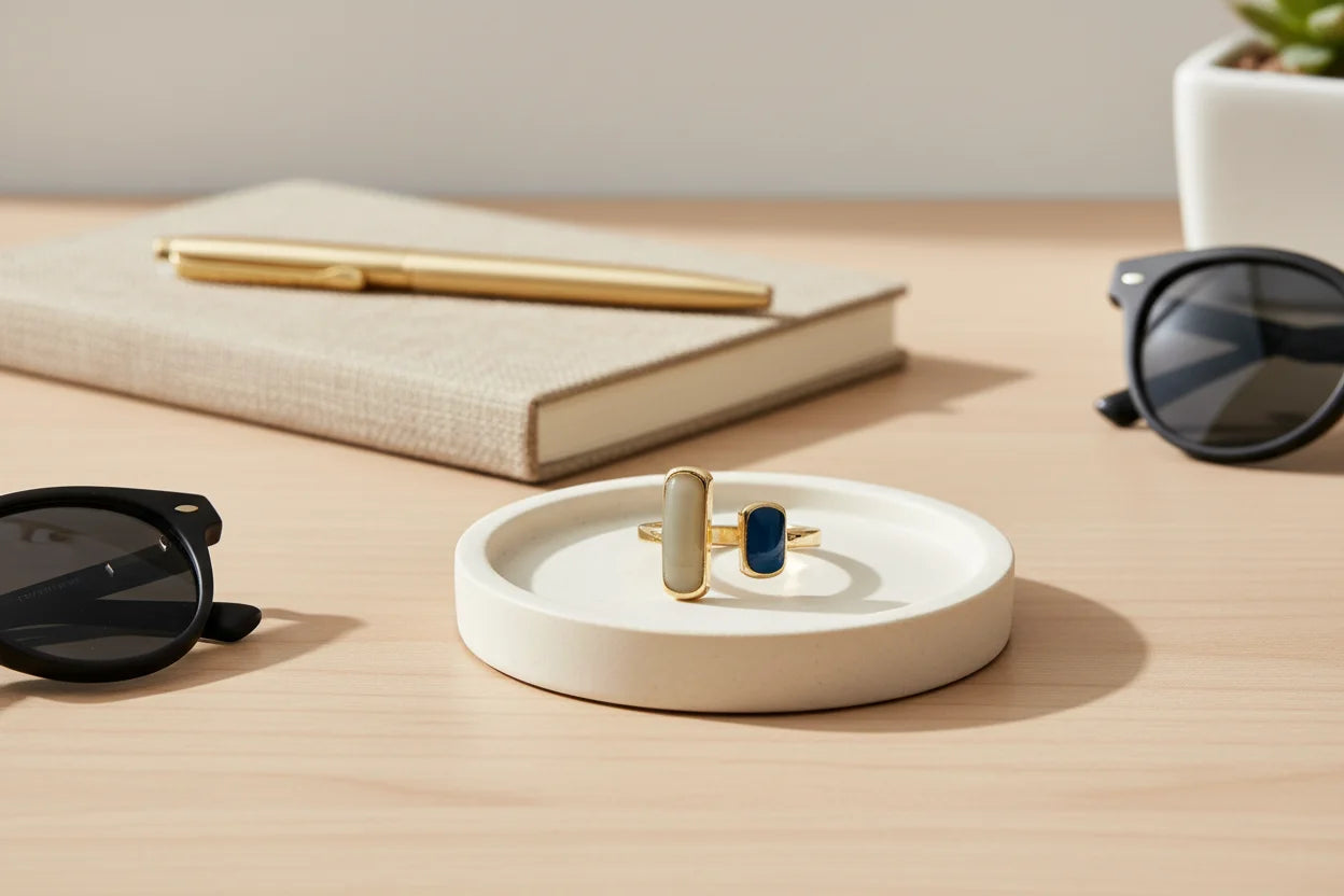 Two Stone Open Ring styled in a ceramic dish on a wooden desk with sunglasses and a notebook, clean flat lay highlighting the two rectangular stones | OriaJewel