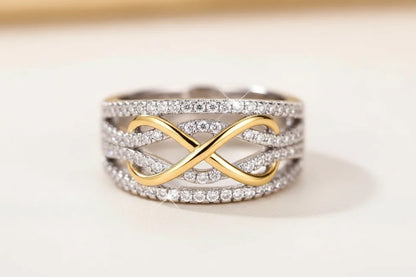 Two Tone Criss Cross Ring macro close-up on a neutral background, detailed view of the gold crossover motif framed by multiple pavé-set silver bands | OriaJewel