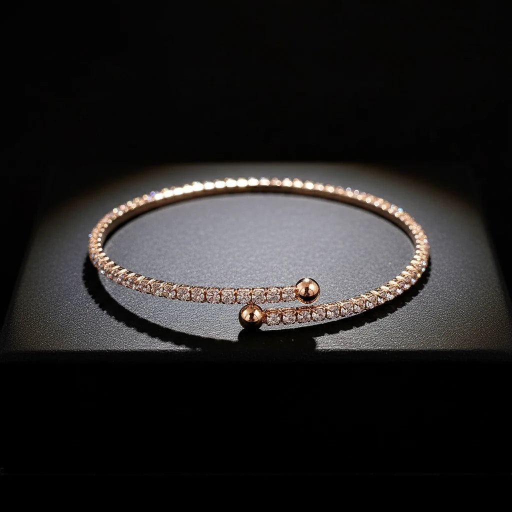 Veluxa Pavé Wrap Cuff in rose gold displayed on a dark pedestal, sparkling cubic zirconia catching dramatic studio light | Oria Jewel