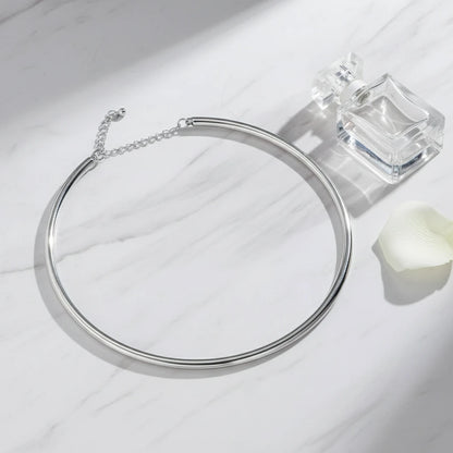Vintage Choker Necklace in silver placed beside perfume bottle on marble background for minimalist styling | Oria Jewel