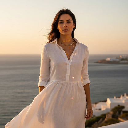 Vintage Choker Necklace in gold worn with white dress at sunset near the ocean, radiating timeless charm | Oria Jewel