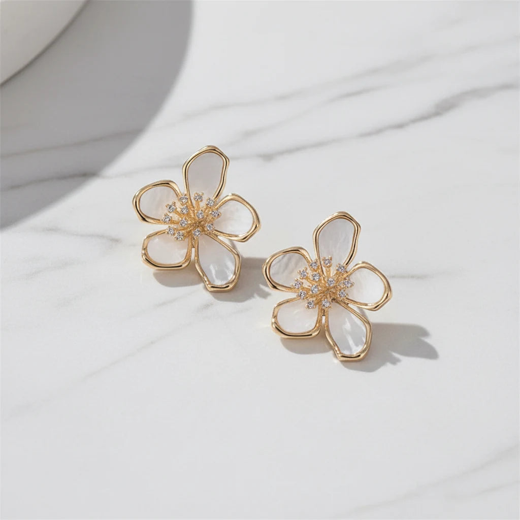 Close-up White Flower CZ Stud Earrings on white marble background | OriaJewel