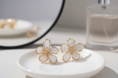 White Flower CZ Stud Earrings on a dish with mirror and perfume | OriaJewel