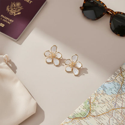 Travel flat lay with White Flower CZ Stud Earrings, passport &amp; shades | OriaJewel