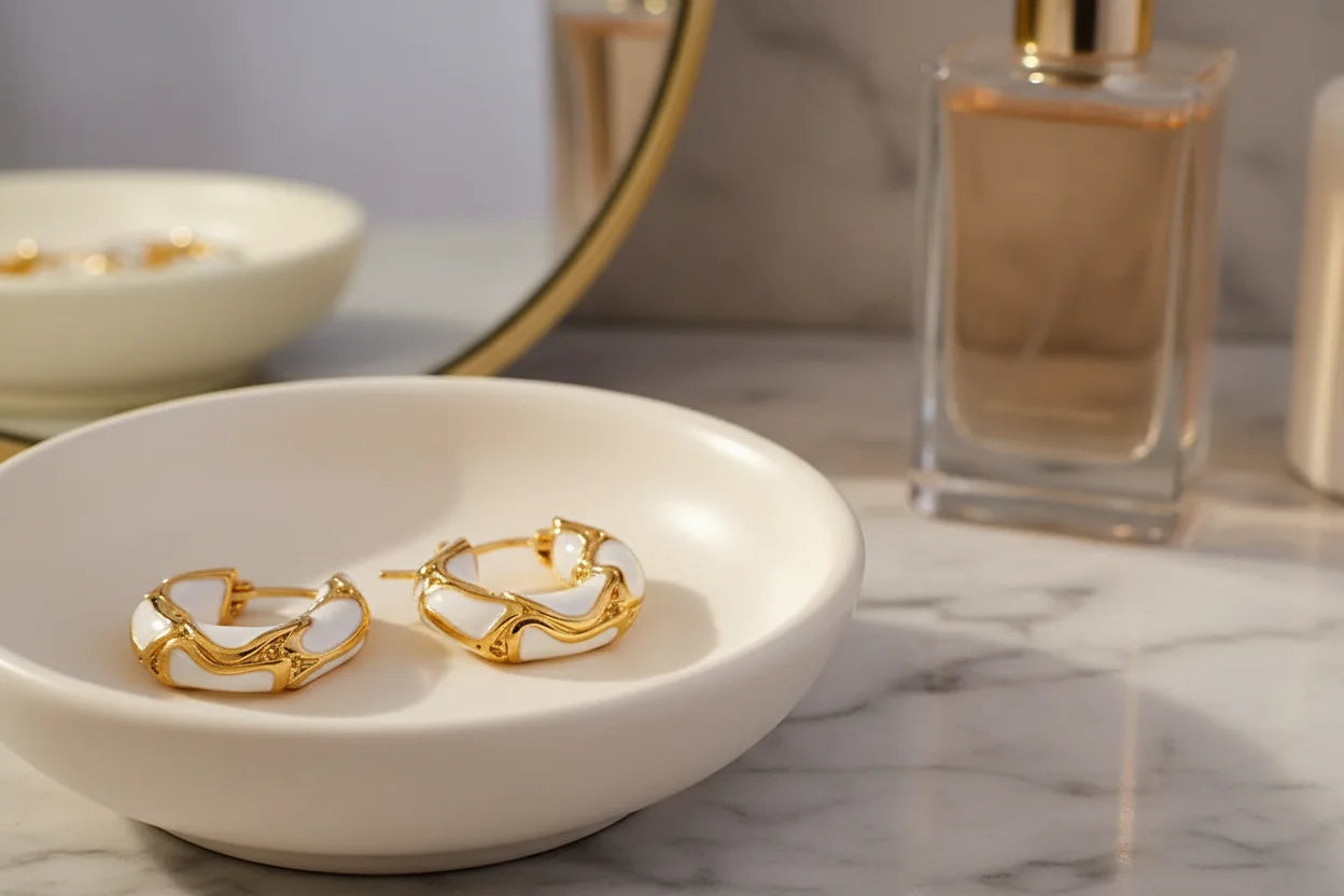 White Huggie Hoop Earrings on white tray with mirror and perfume bottle | OriaJewel