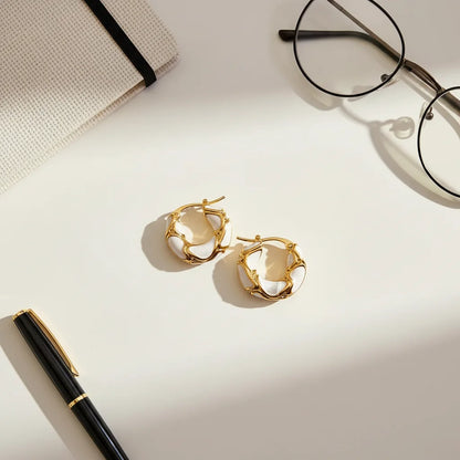 White Huggie Hoop Earrings flat lay on white desk with glasses and pen | OriaJewel