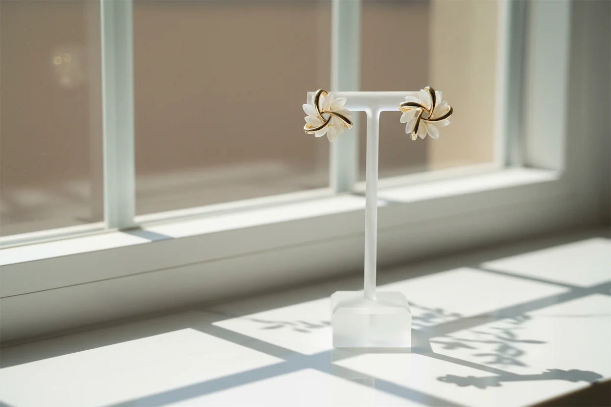 White Petal Cluster Stud Earrings on white stand by window light | OriaJewel
