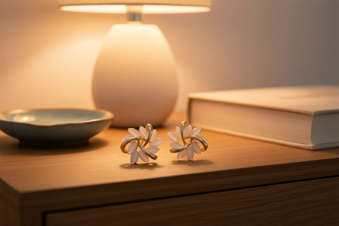 White Petal Cluster Stud Earrings on nightstand with warm lamp glow | OriaJewel