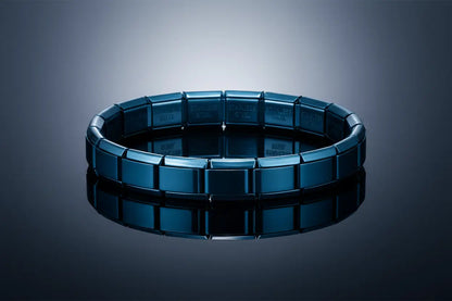 High-end studio shot of a perfectly round blue stainless steel stretch bracelets displayed on a glossy reflective surface, with cool gradient lighting enhancing the mirror-like shine and contemporary stainless-steel links | Oria Jewel