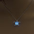 Close-up of round glowing moon locket pendant with silver chain | Oria Jewel
