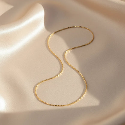 Minimalist Flat Chain Choker on smooth satin fabric — elegant gold shine with subtle texture | Oria Jewel